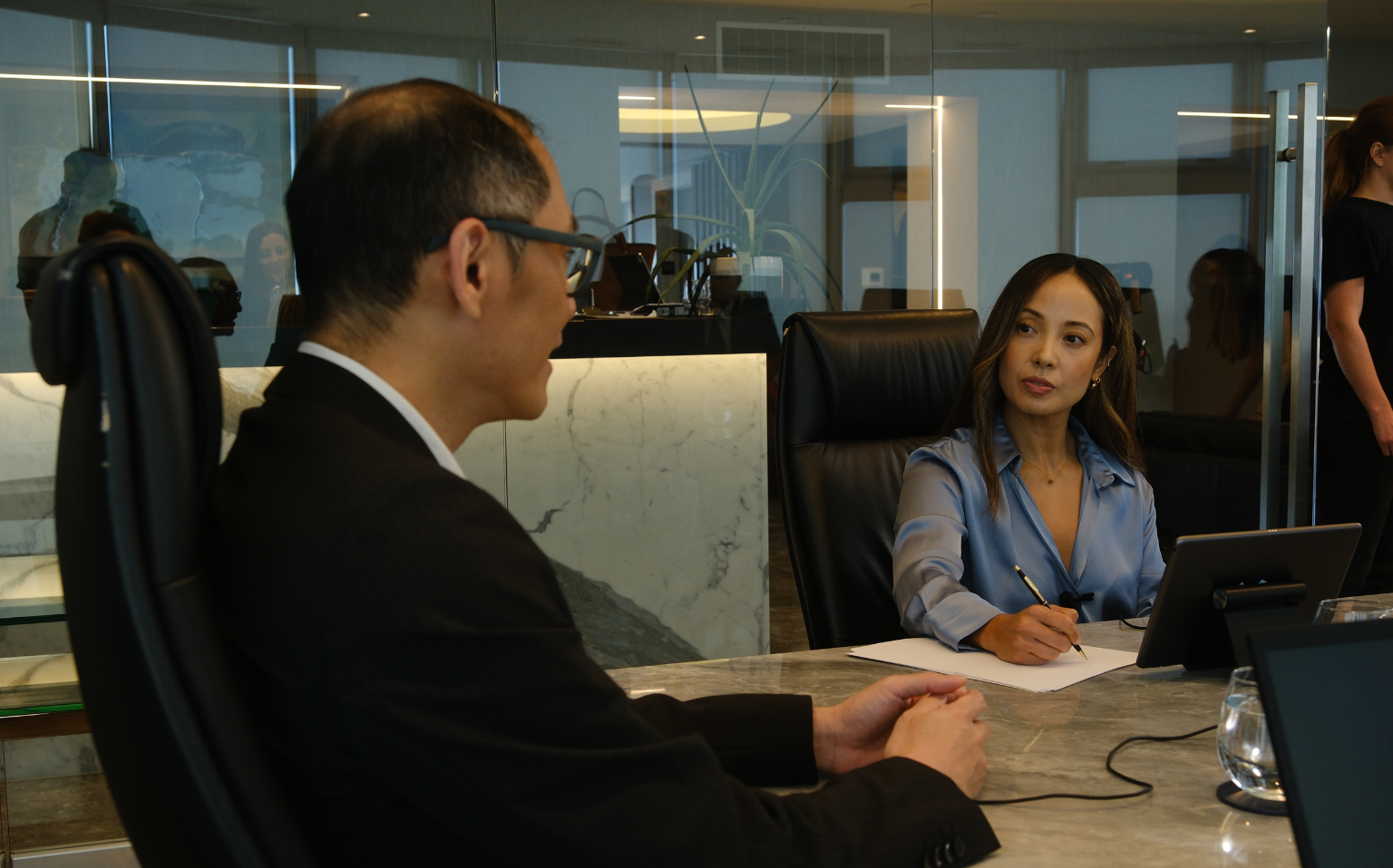 Interpreter and witness at a table during an international deposition