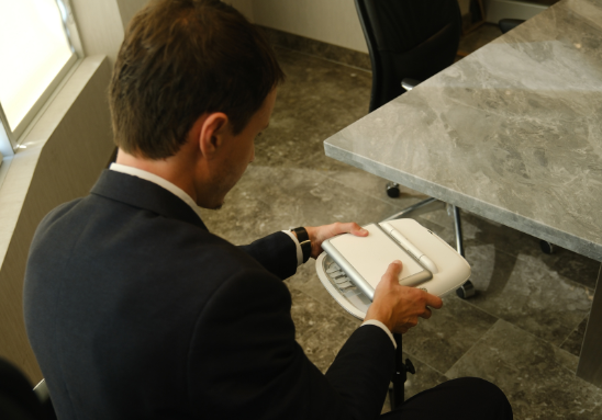 Male stenographic court reporter setting up his stenotype machine
