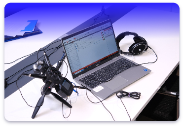 Set up of digital reporting equipment including headphones, microphone and laptop